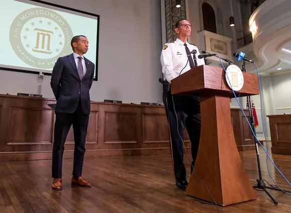 Montgomery Mayor Steven Reed, left, listens as Police Chief Darryl Albert speaks a news conference at City Hall in Montgomery, Ala