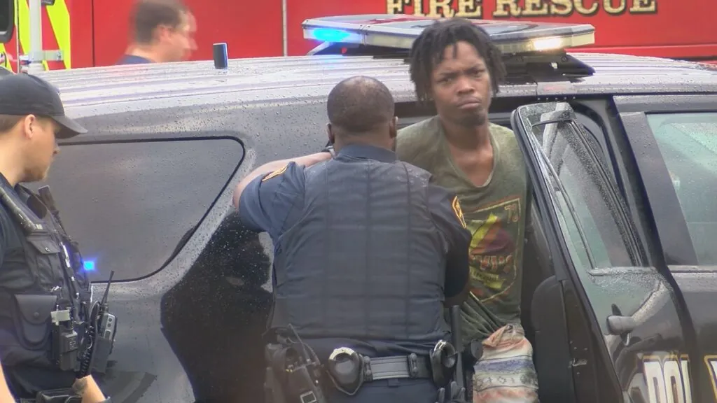 One of two unidentified suspects is placed in a Montgomery police SUV after a chase ended Friday with a crash into an unmarked police unit on I-85.