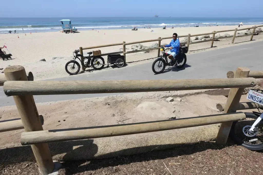 A man rides an e-bike near Bluff Top Park in Huntington Beach in 2022