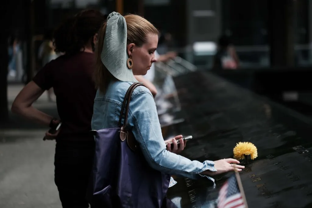 NEW YORK, NEW YORK - AUGUST 31: A woman mourns a relative at the September 11 Memorial at Ground Zero on August 31, 2021 in New York City. New York City and much of the nation are preparing for the 20th anniversary of the terrorist attacks in both New York City and Washington D.C. Yesterday the United States officially ended its participation in the war in Afghanistan, a two-decade-long conflict that began shortly after the terrorist attacks of September 11, 2001. Almost 2,500 U.S. service members have died in the conflict, and thousands of Afghan troops, police personnel and civilians have also been killed. (Photo by Spencer Platt/Getty Images)
