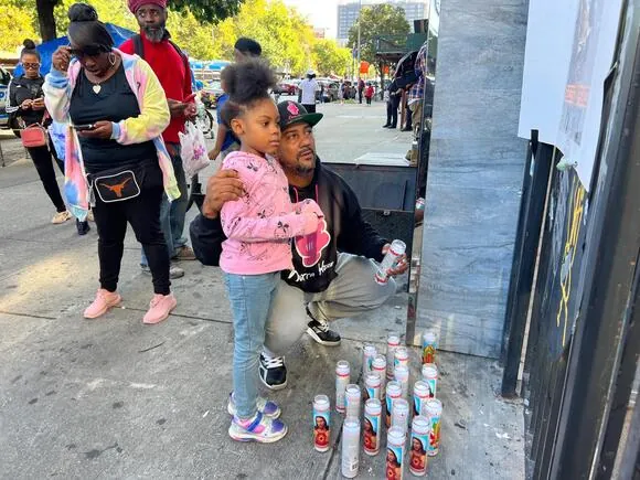 Neighbors paid their respects at a makeshift memorial near the scene of the shooting.