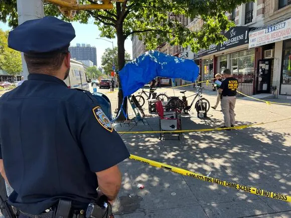 Police taped off a tent on West 142 Street and Lenox Avenue in Harlem after a shooting on Wednesday morning.