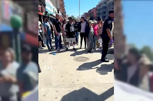 Residents gather at the scene of Thursday's shooting in Mott Haven that left a 71-year-old woman dead.