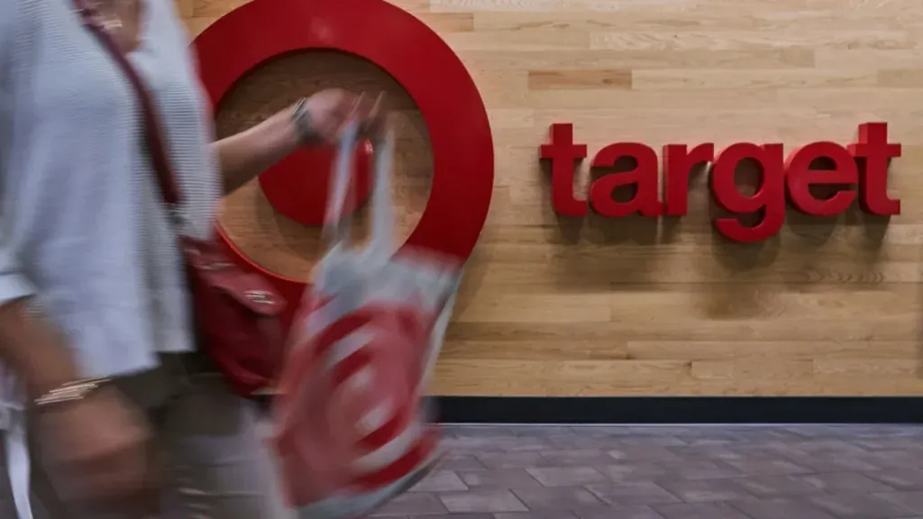 Target customer walking by the store sign.