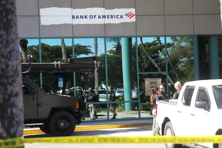 Officers outside the Bank of America branch in Fort Meyers on Tuesday